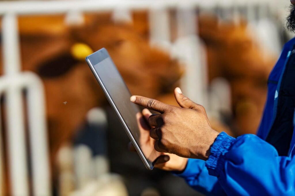 A worker using a tablet to review industrial equipment data.